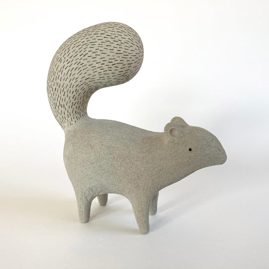 Ceramic squirrel figurine on a white background