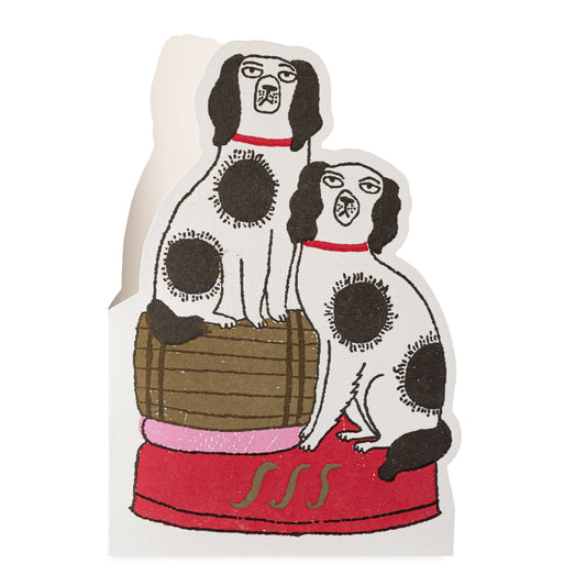 Illustration of two black and white spotty dogs, one standing on a barrel on a white background with a red base.