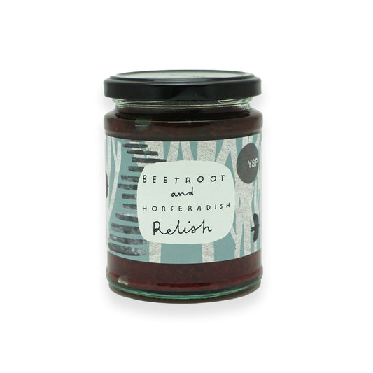 A glass jar with a black lid and blue label featuring illustrations of trees and birds.