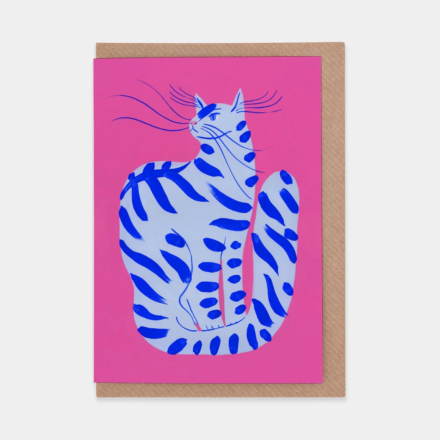 A greeting card featuring a stylised illustration of a blue and white striped cat sitting gracefully against a vibrant pink background. The cat has long whiskers and a relaxed posture, adding a playful touch to the design.