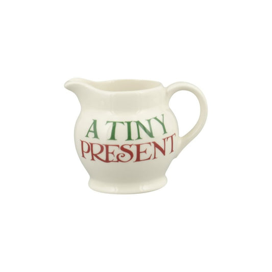 Small white pitcher with 'A Tiny Present' text on a white background