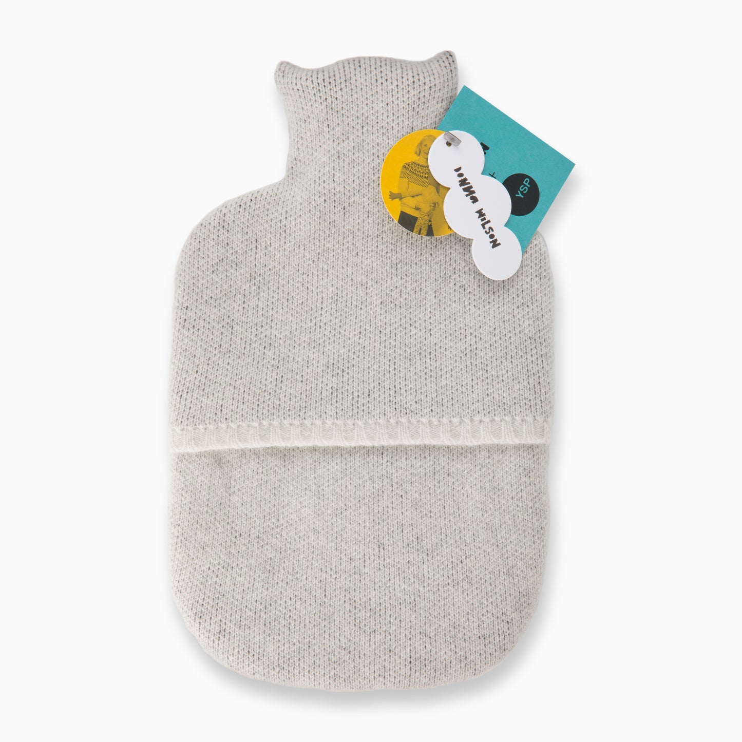 The back of a grey wool hot water bottle that features Donna Wilson cardboard tags.
