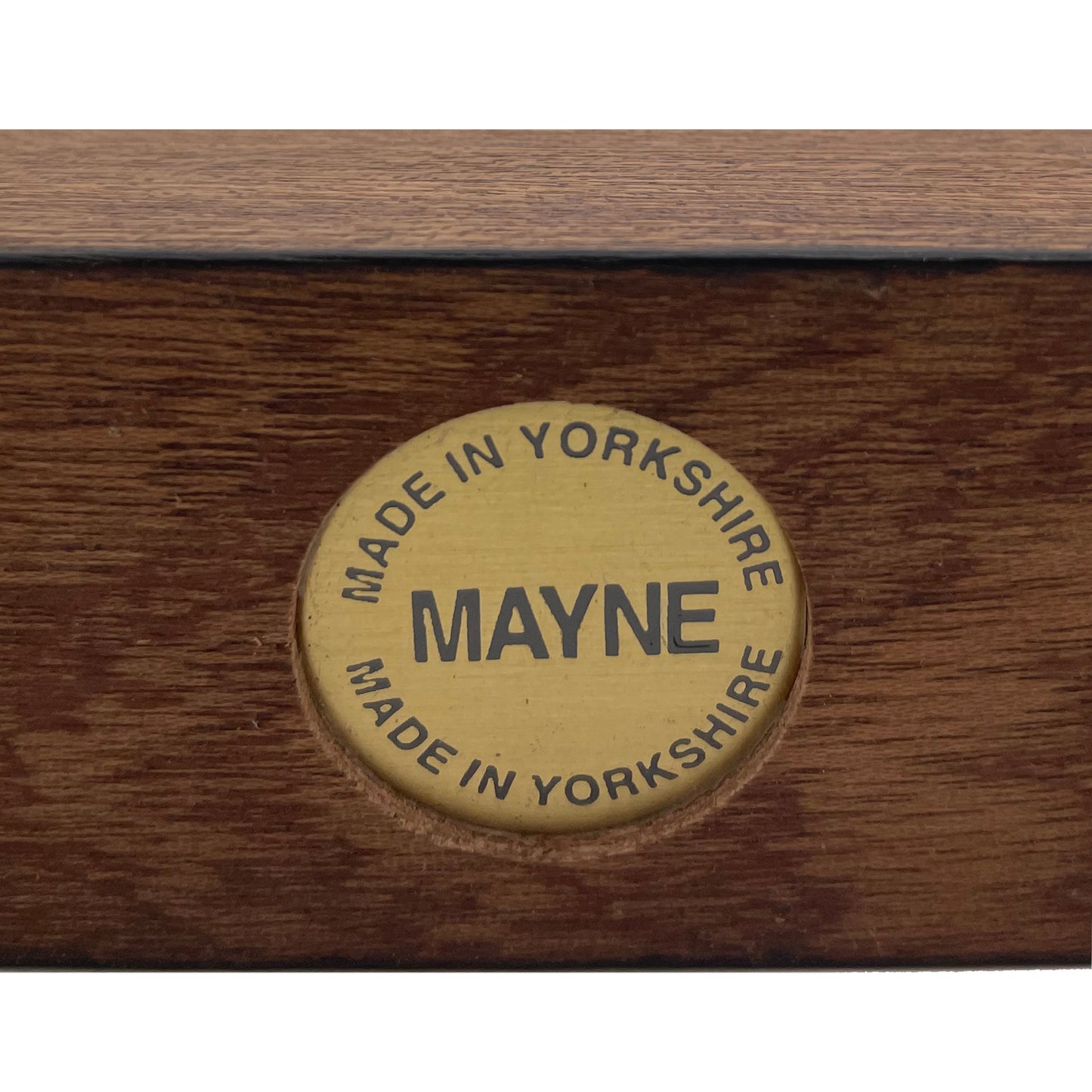 A brass base disc stamp featuring the works 'Made In Yorkshire' and 'Mayne'.