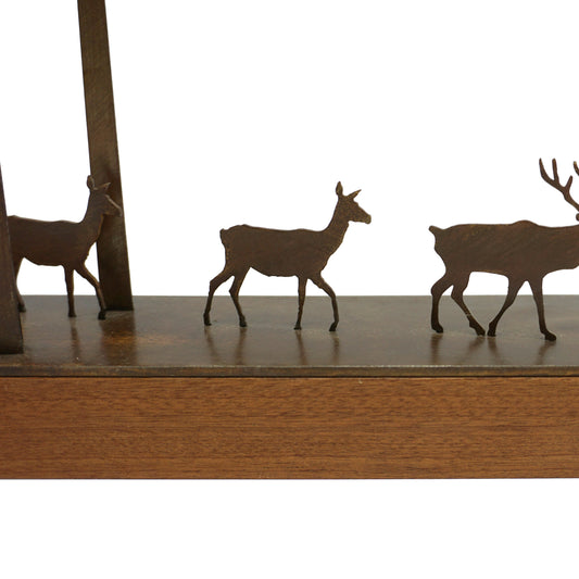 Close up of two laser cut deer figurines and a stag on a wooden base.