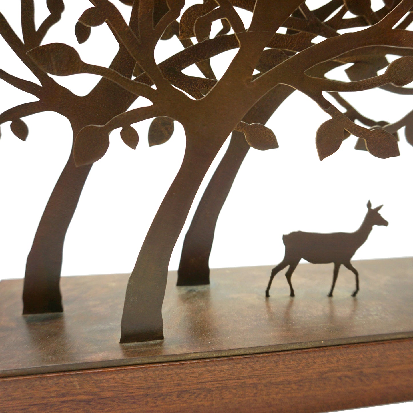 A steel and wood mini sculpture featuring laser cut trees that form a tunnel where a single deer sits in the middle.