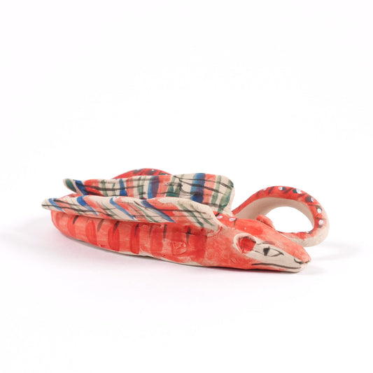 A pink, orange and blue ceramic whistle in the shape of an asp on a plain white background.