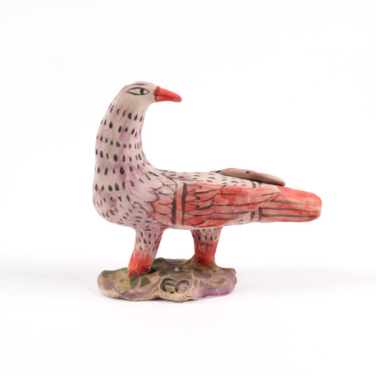 Painted ceramic bird whistle with a red beak and patterned body on a plain white background.