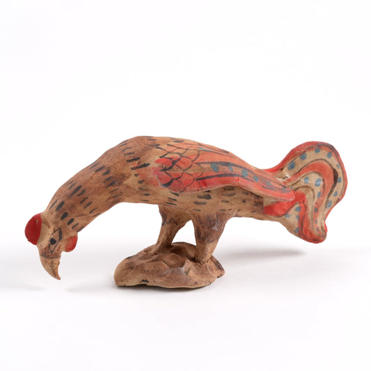 Ceramic rooster painted whistle with red accents on a white background