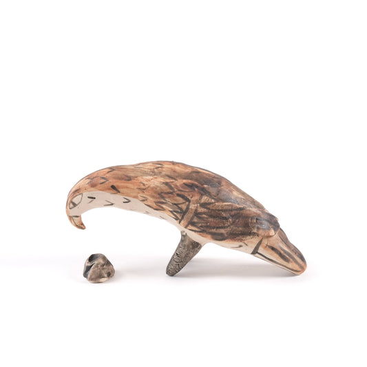 A painted ceramic eagle whistle in shades of brown and beige on a plain white background.