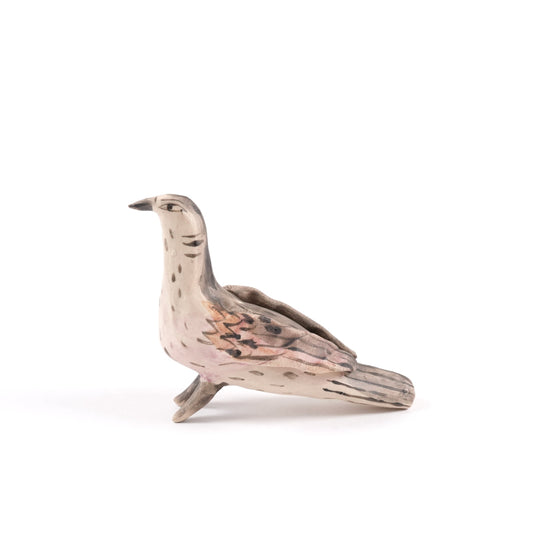 A painted ceramic turtle dove whistle in shades of brown and beige on a plain white background.