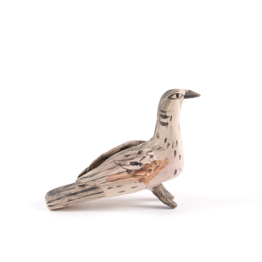 A painted ceramic turtle dove whistle in shades of brown and beige on a plain white background.