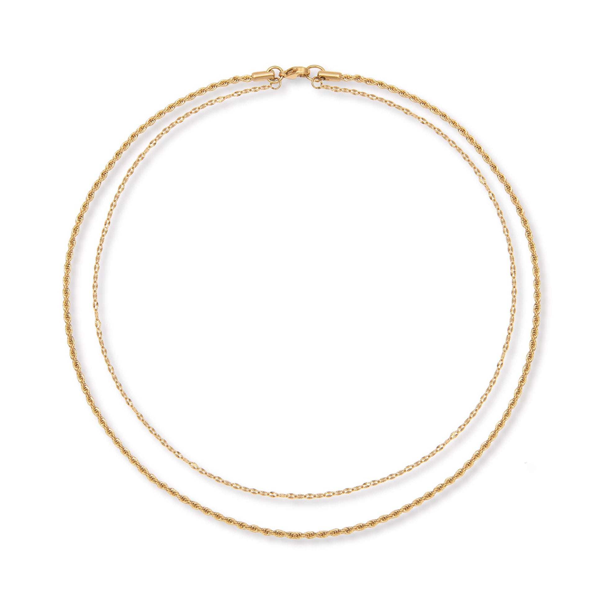 Two gold chains layered on top of each other joined into one necklace at the top on a white background.