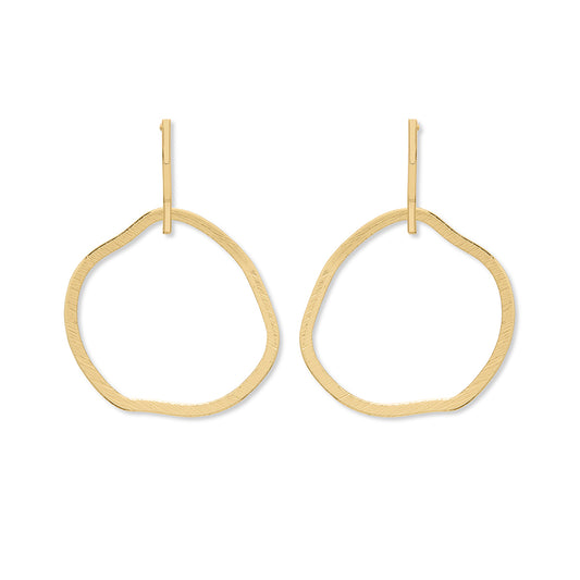 A pair of gold stud earrings featuring a large dangle circle hoop underneath.