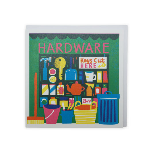 A vibrant illustration of a hardware store front, featuring shelves filled with tools, paint cans, and household items. Brightly coloured buckets and a broom are displayed in the foreground, with a sign reading "Keys Cut Here" prominently featured.
