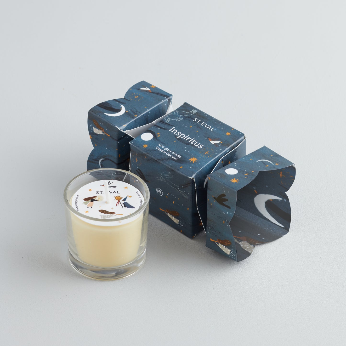 A small glass candle in a decorative box with 'St Eval' branding, featuring a stars and crescent moon design, and labelled 'Inspiritus'.