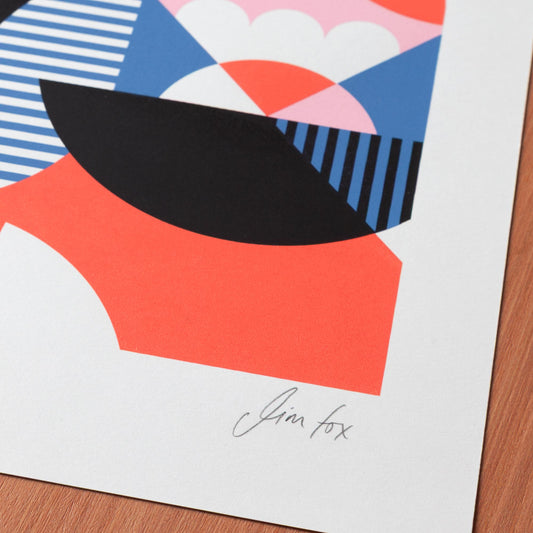 Colorful abstract geometric design print on a wooden surface.