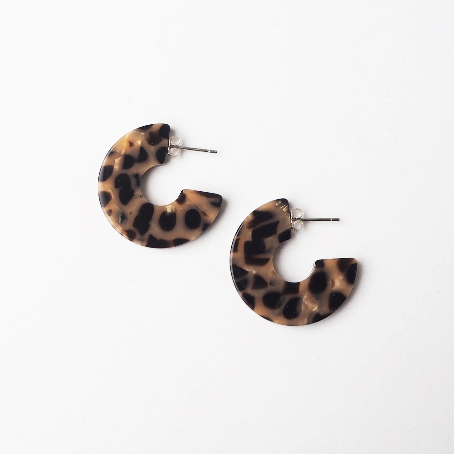 Leopard print hoop earrings on a white background
