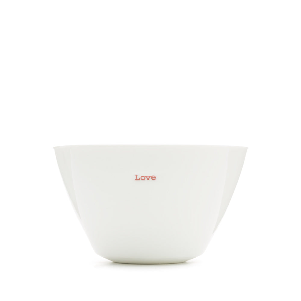 A white porcelain bowl with the word 'Love' stamped in red typewriter font on the front.