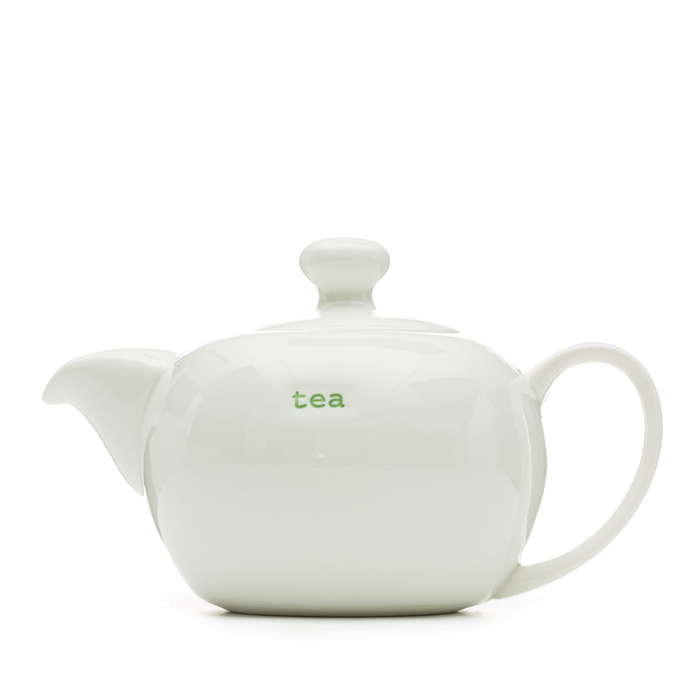 A white ceramic tea pot with 'tea' text on the side, designed by Keith Brymer Jones.