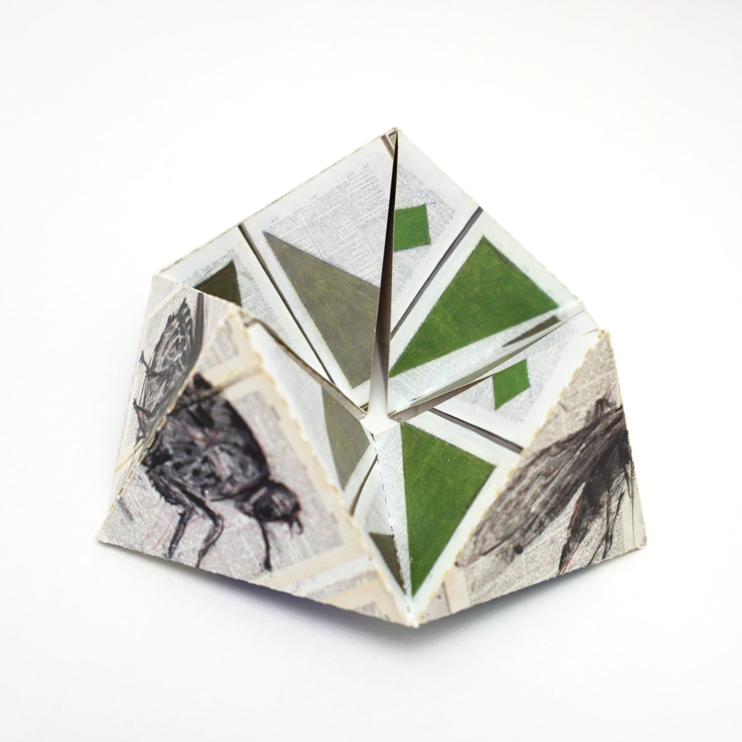 Geometric paper sculpture with geometric patterns on a white background