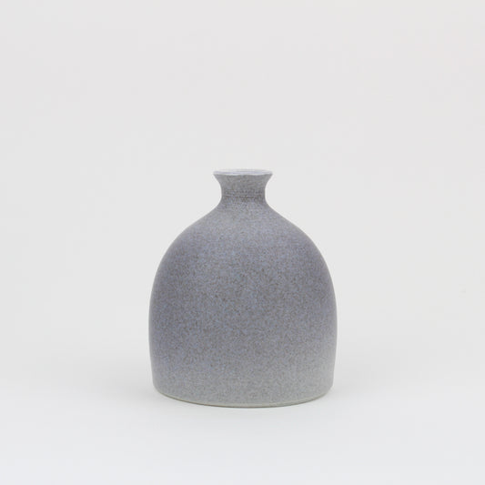 A hand thrown earthenware grey vase with a speckled matt glaze.