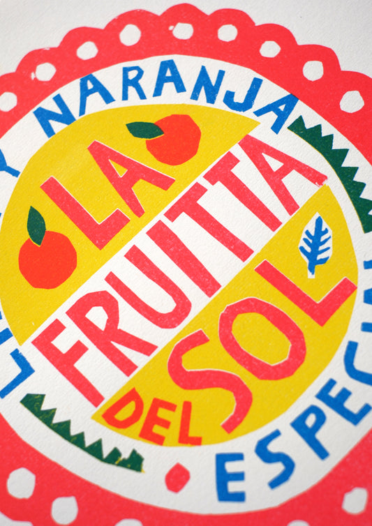A vibrant, decorative label featuring the text "LA FRUITTA DEL SOL ESPECIAL" in bold, colourful letters. The design includes illustrations of lemons and oranges, framed by a scalloped red border on a light background.