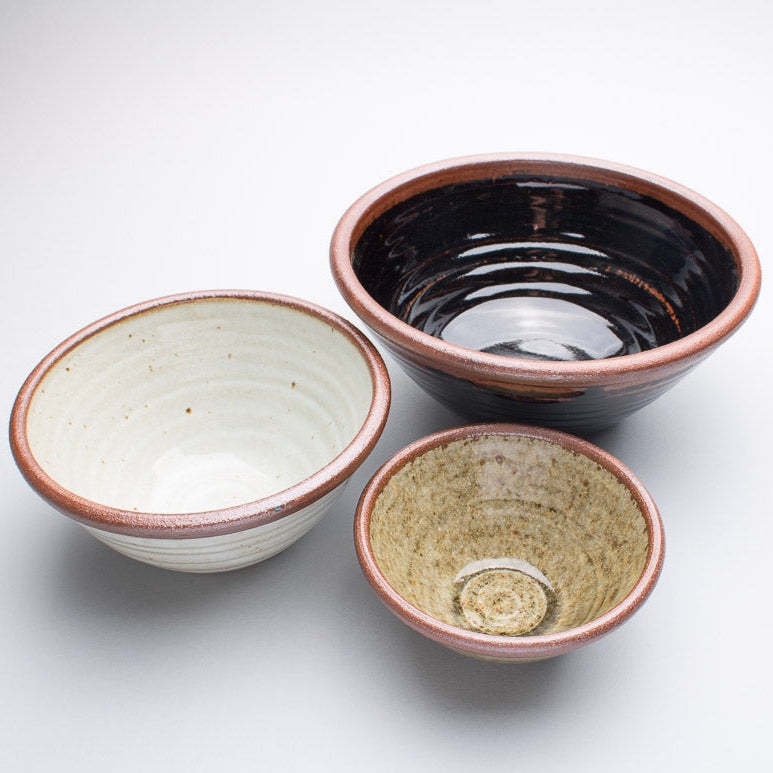 A set of three Leach Pottery bowls all in different sizes and glazes
