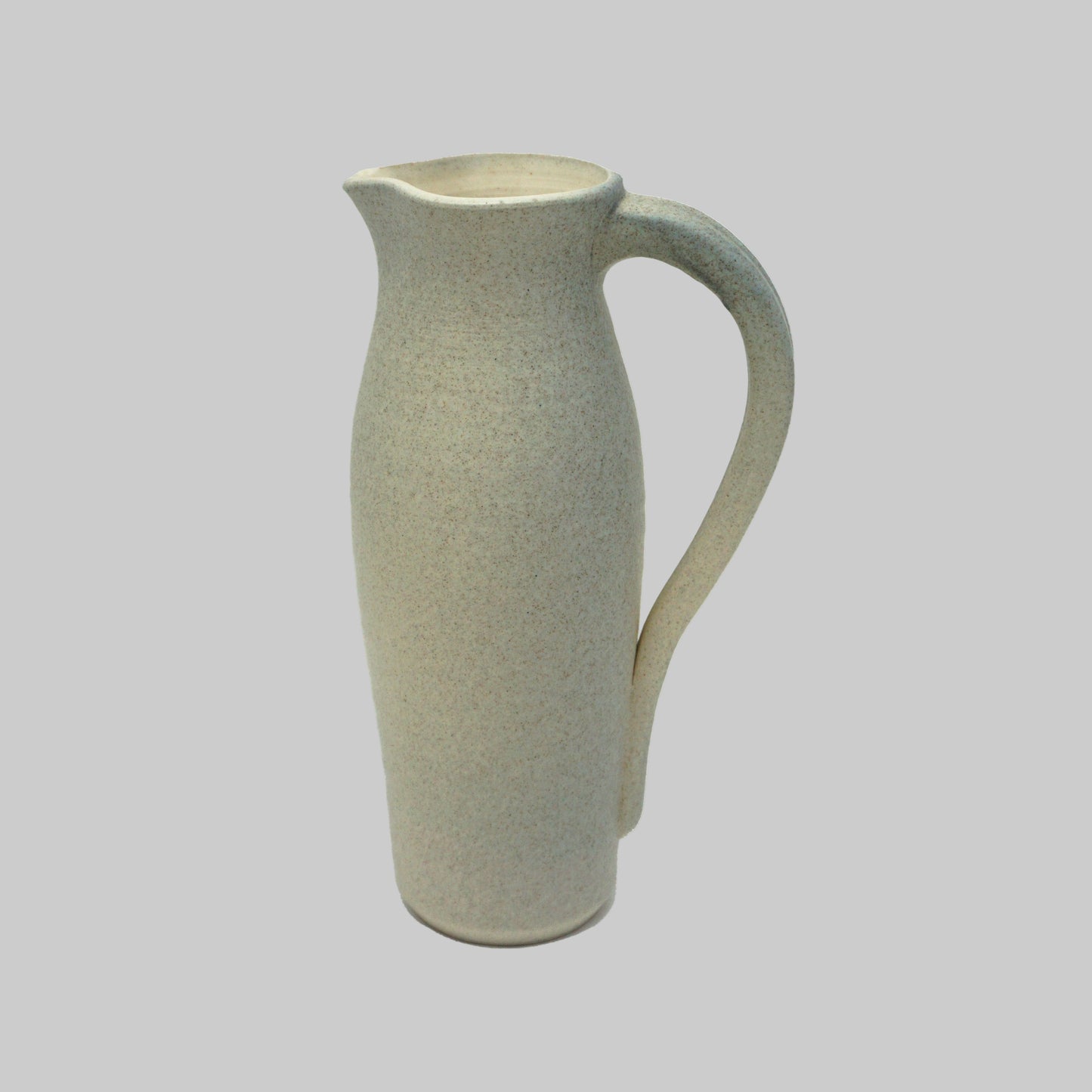 Ceramic grey pitcher with a textured surface on a white background