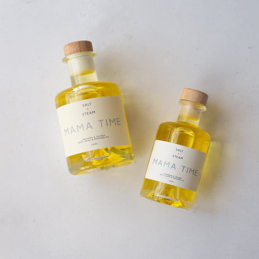Two different sized bottles of 'Mama Time' on a light background