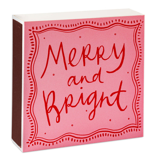 Pink box with red 'Merry and Bright' text on a white background