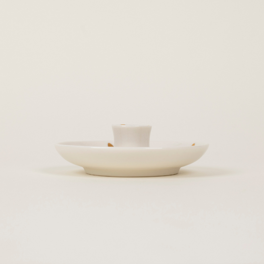 White ceramic dish with a small white container on a light beige background