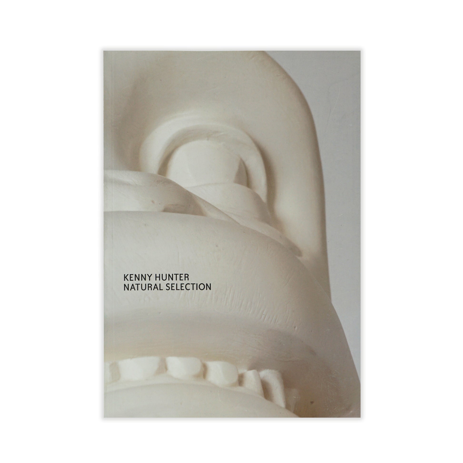 Cover of the exhibition catalogue 'Kenny Hunter: Natural Selection' featuring a white stone sculpture with 'Kenny Hunter' text overlay.