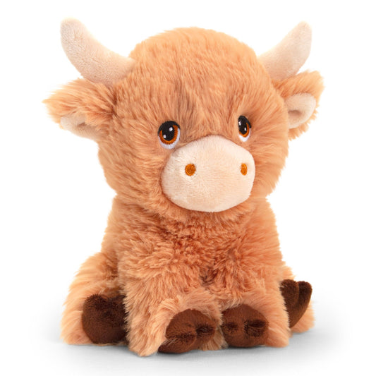 A soft, plush toy resembling a Highland cow. It has a fluffy orange-brown body, small brown hooves, and large, expressive eyes. Its ears are rounded, and it features two small, curved horns on its head, giving it a cute and cuddly appearance.