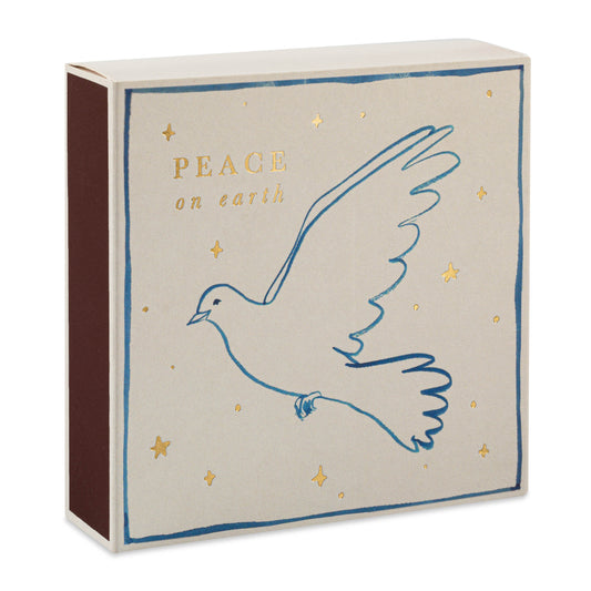 A box of matches with a 'Peace on Earth' message and a white dove illustration, surrounded by gold text and stars.