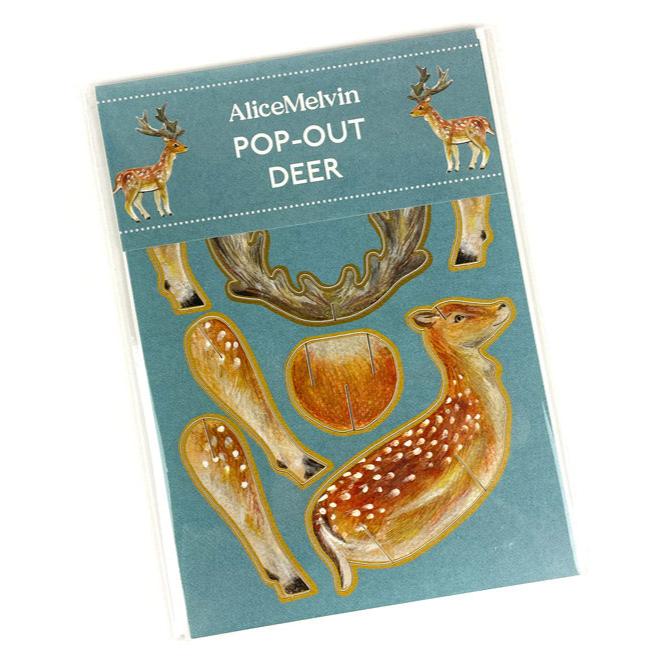 A 3D card titled "Pop-Out Deer" by Alice Melvin. The packaging features illustrations of a deer, its antlers, and legs, all set against a blue background. The design is playful and suitable for creative activities.