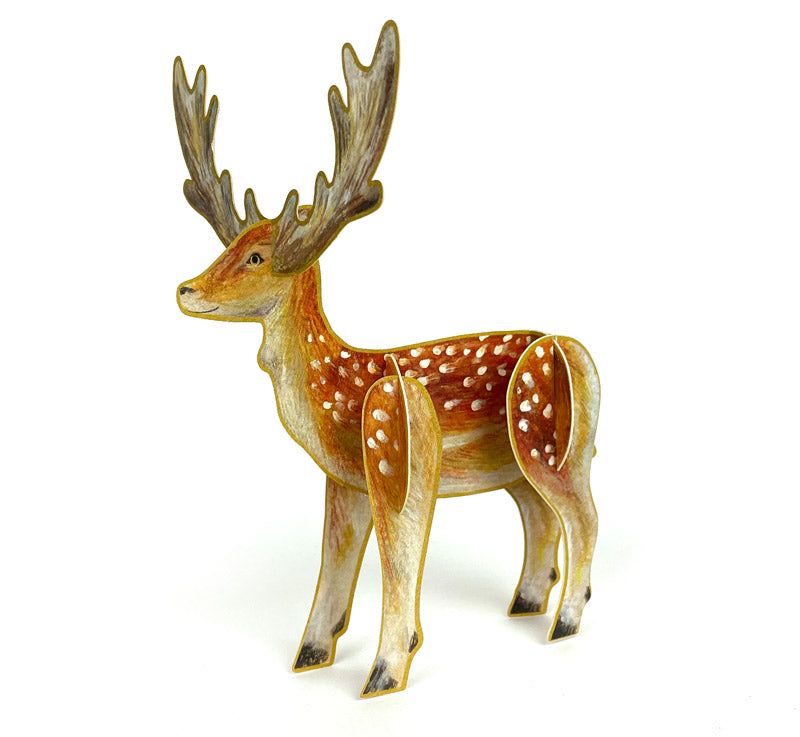 A three-dimensional pop-up card featuring a beautifully illustrated deer with antlers and a spotted coat. The 3D card is set against a plain white background.