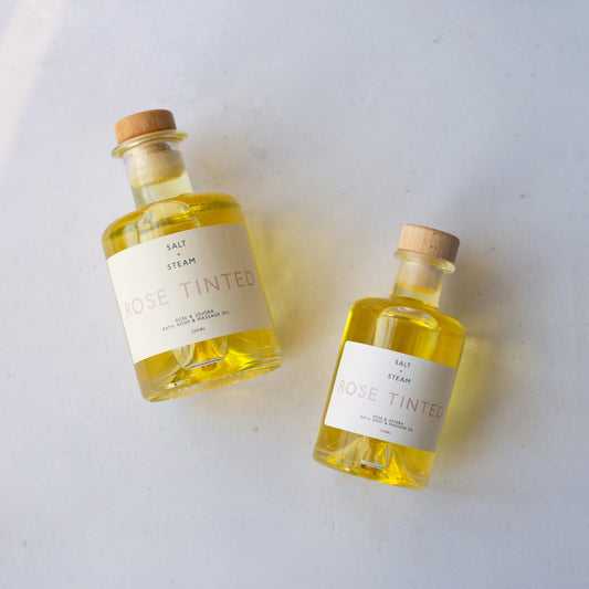 Two bottles of 'Rose Tinted' oil on a light background