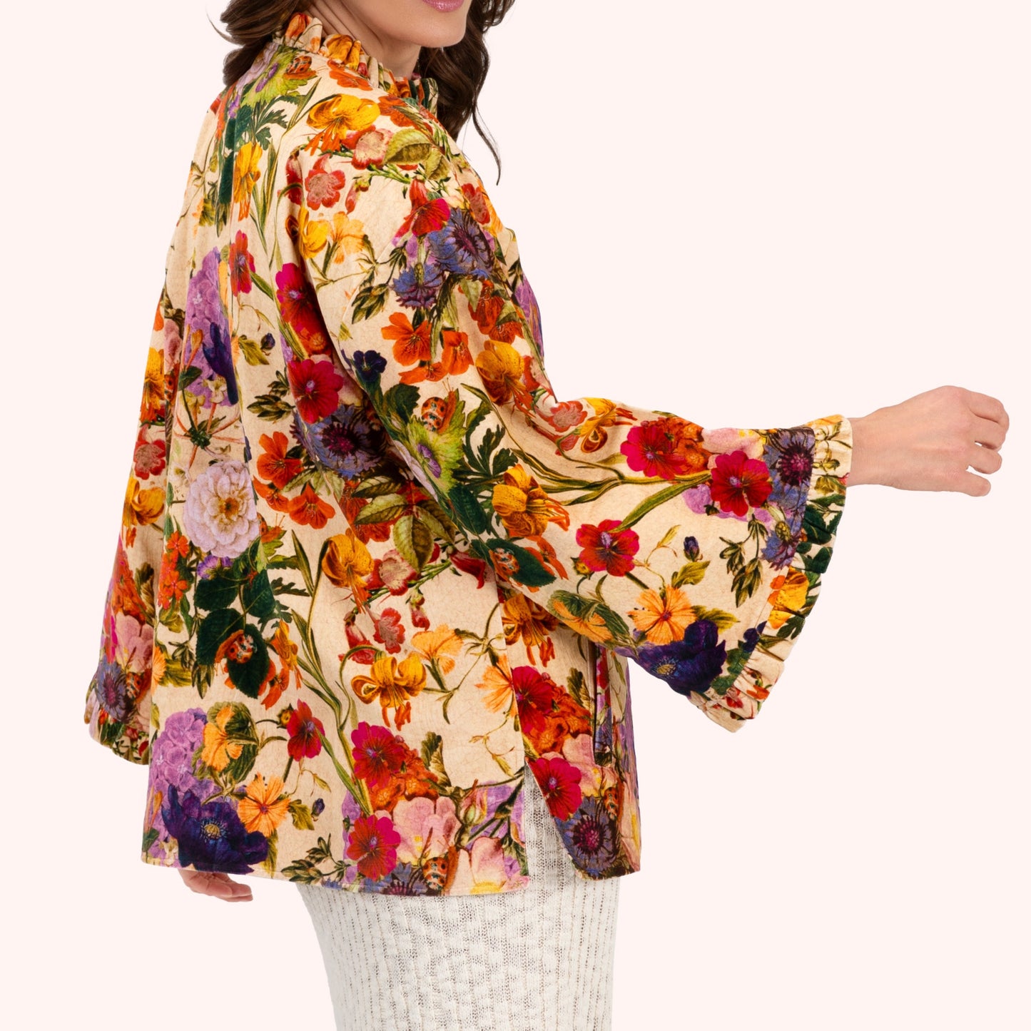 Woman wearing a colorful floral jacket on a white background