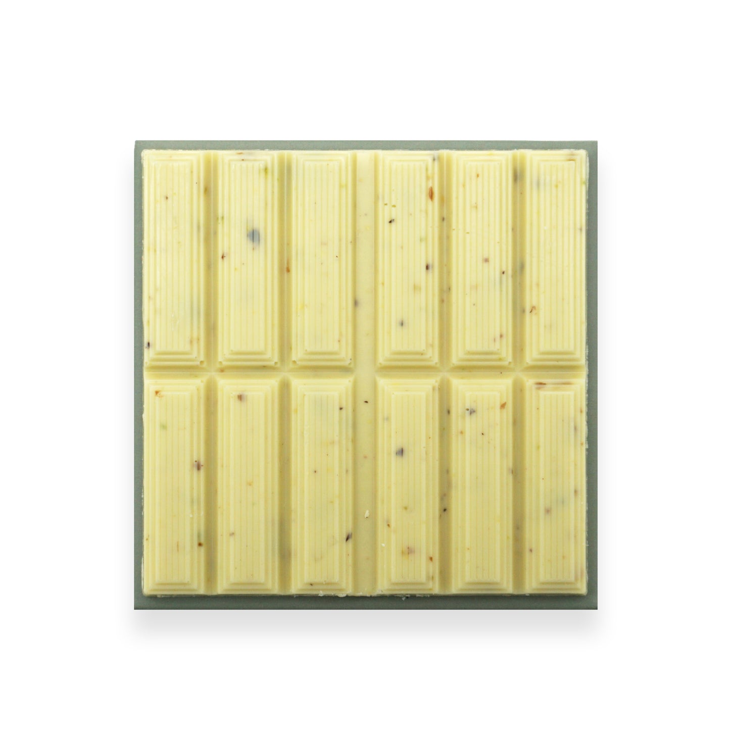 A square bar of white chocolate sitting on a blue cardboard packet.