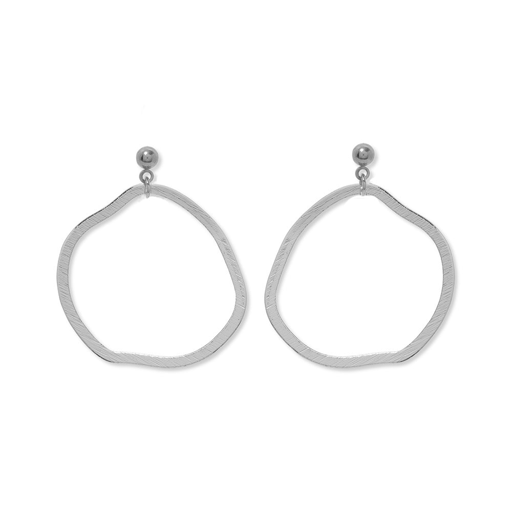 A pair of silver stud earrings featuring a large dangle circle hoop underneath.