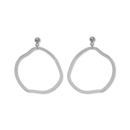 A pair of silver stud earrings featuring a large dangle circle hoop underneath.