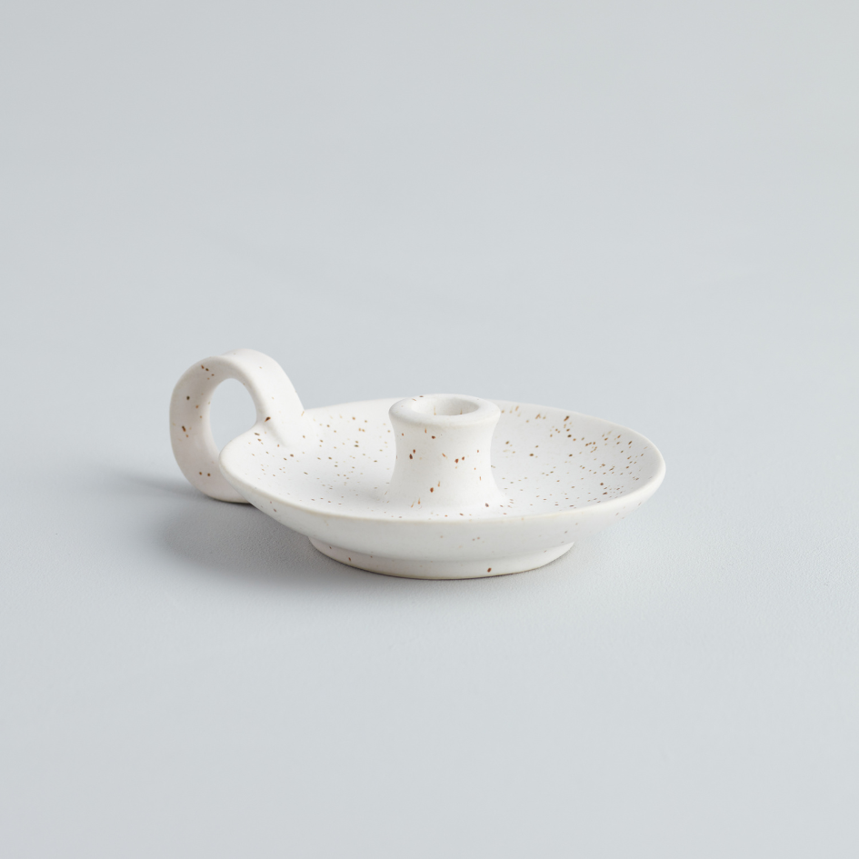 A white speckled ceramic mini candle holder with a handle, displayed against a plain background.