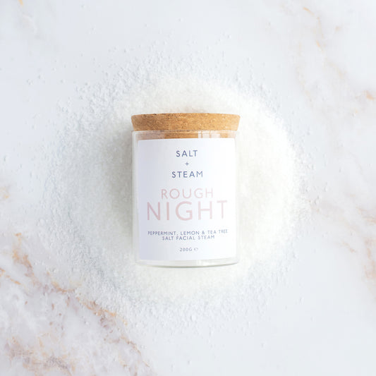 Facial Steam labelled 'Rough Night' by Salt + Steam on a marble surface