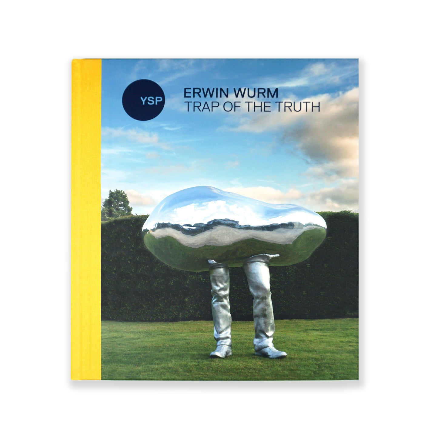 A book cover featuring a shiny, oversized sculpture resembling a bean, with a person dressed in silver trousers and a reflective top. The background shows a neatly trimmed hedge under a blue sky. The title reads "Erwin Wurm: Trap of the Truth.