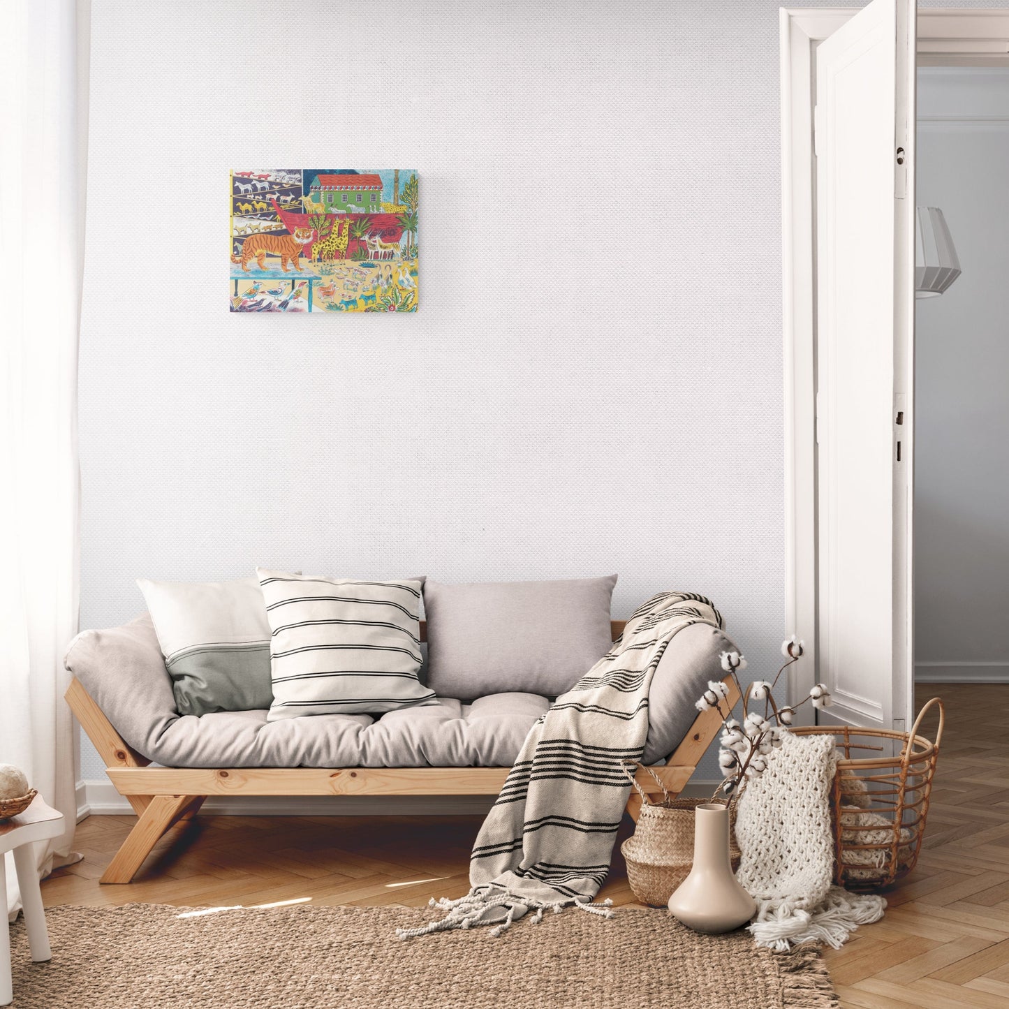 A lounge room with a grey sofa and cream blankets with a to scale version of Emily Sutton's wo by Two screen print hung on the wall.