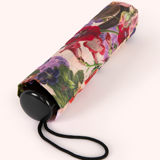 Floral-patterned umbrella with a black handle on a white background