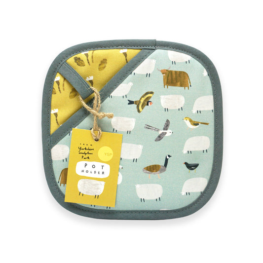 A square pot holder featuring a whimsical design of sheep, birds, and farm animals on a light blue background. It has a contrasting mustard yellow section and is finished with a grey border. A yellow tag reads "Pot Holder.