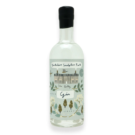A large glass bottle with black wax dipping on the neck, with a blue label featuring illustrations of botanicals found around Yorkshire Sculpture Park.