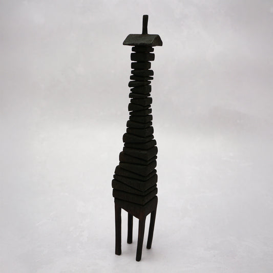 Black wooden house sculpture on a white background