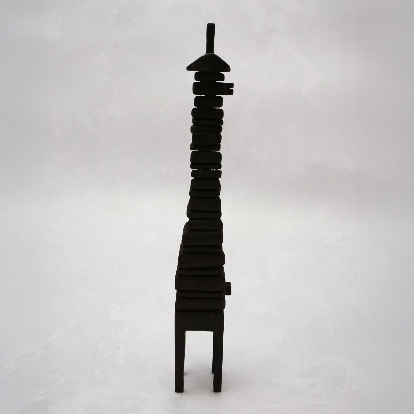 Black wooden house sculpture on a white background